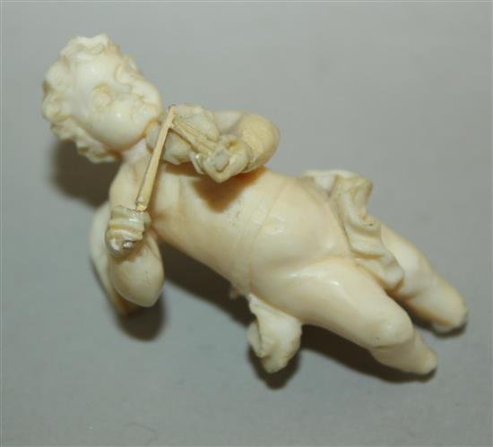 A pair of late 19th / early 20th century European carved ivory figures of winged cherubs, 4.25in. some damage